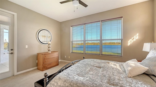 bedroom with light carpet, access to outside, and ceiling fan