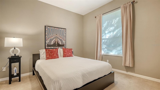 bedroom featuring light colored carpet