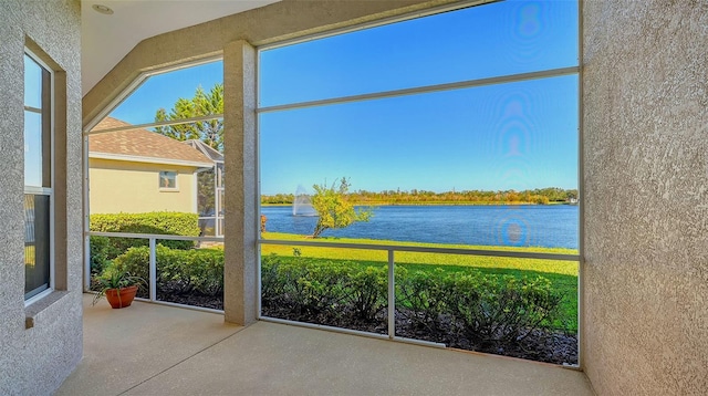 unfurnished sunroom with a water view and lofted ceiling