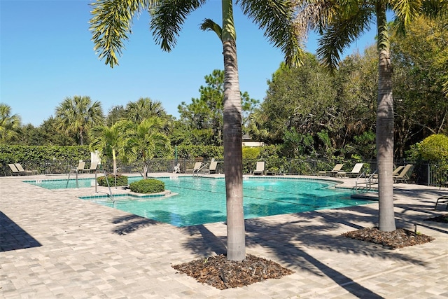 7407 Sea Island Ln, Bradenton, FL 34201 - community pool with a patio and view of scattered trees