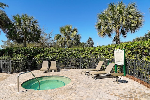 view of swimming pool with a community hot tub and a patio