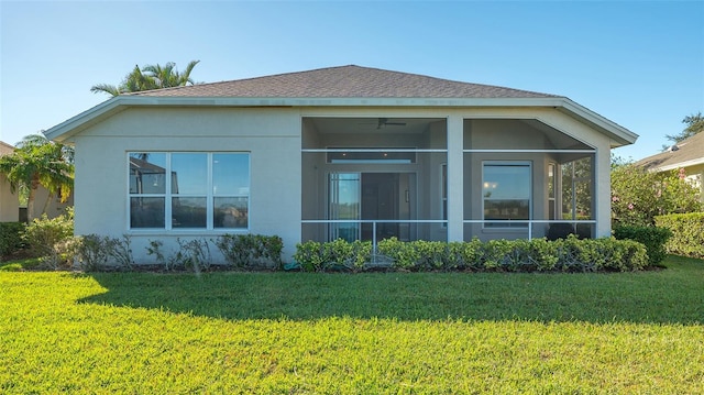 7407 Sea Island Ln, Bradenton, FL 34201 - rear view of property featuring stucco siding, a lawn, and a sunroom