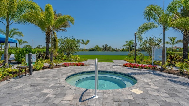 view of swimming pool featuring a hot tub