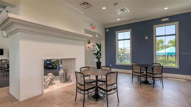 tiled dining room featuring crown molding