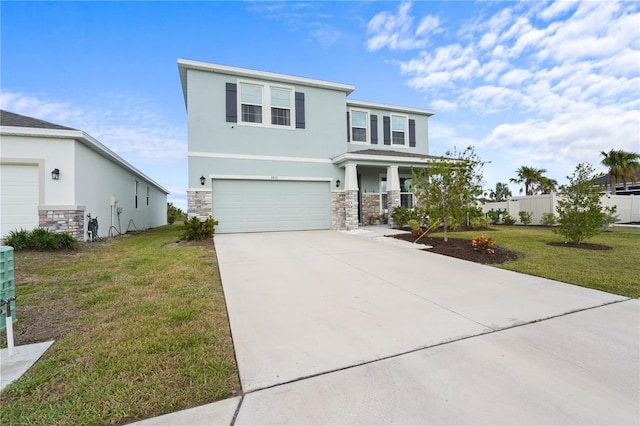 view of front facade with stone siding, a front lawn, concrete driveway, and stucco siding