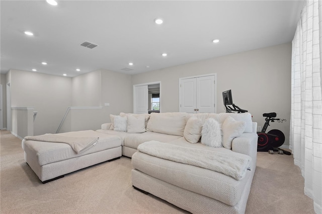 living room with recessed lighting, visible vents, and light carpet