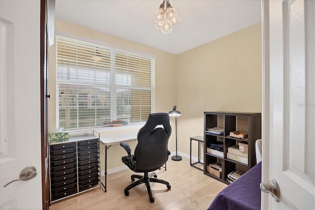 office area featuring light hardwood / wood-style flooring and a chandelier