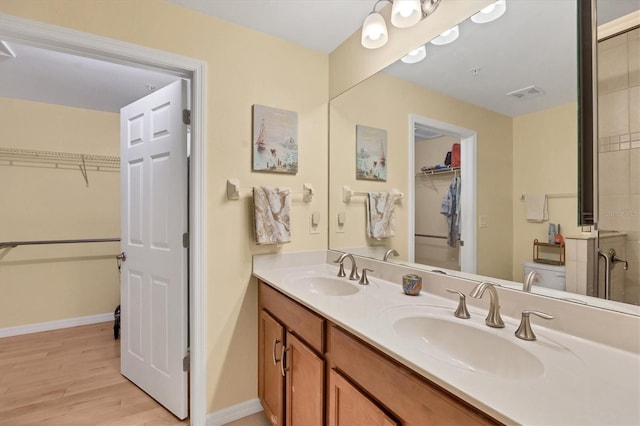 bathroom featuring vanity, wood-type flooring, and toilet