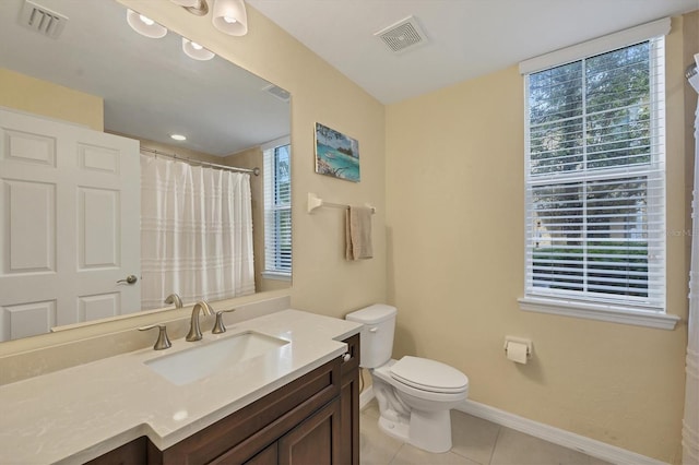 bathroom featuring tile patterned floors, walk in shower, vanity, and toilet