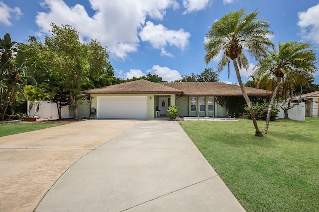 view of front of property featuring a front yard and a garage