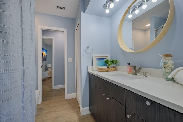 bathroom featuring vanity and hardwood / wood-style flooring