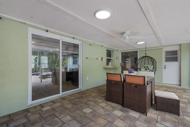 interior space with ceiling fan