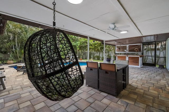 unfurnished sunroom featuring ceiling fan