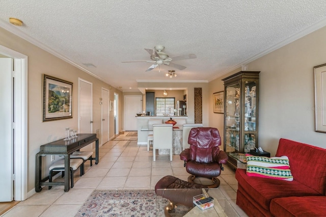 living room featuring light tile patterned floors, a textured ceiling, ceiling fan, and ornamental molding