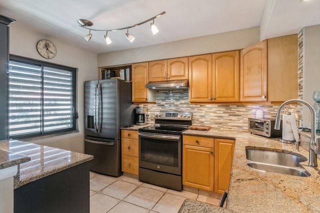 kitchen featuring backsplash, light stone counters, sink, and stainless steel appliances