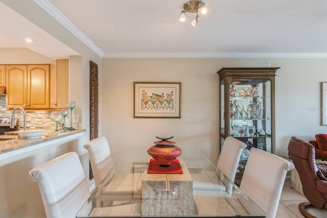 dining room with a textured ceiling, crown molding, and light tile patterned flooring