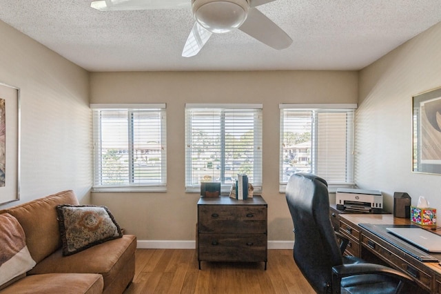 home office featuring ceiling fan, a textured ceiling, and light wood-type flooring