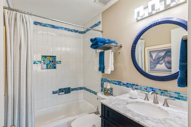 full bathroom featuring vanity, toilet, and shower / bathtub combination with curtain