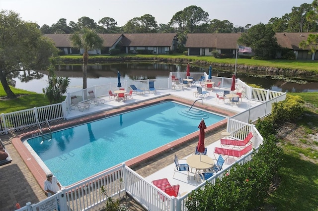 view of pool featuring a patio area and a water view