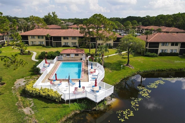 exterior space featuring a patio area, a yard, and a water view