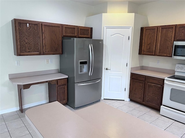 kitchen with light tile patterned flooring, dark brown cabinets, and appliances with stainless steel finishes