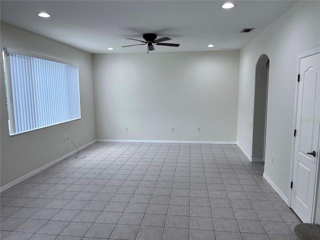 tiled spare room with ceiling fan