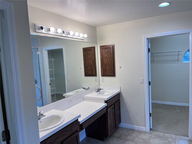 bathroom featuring vanity, a textured ceiling, and tile patterned floors