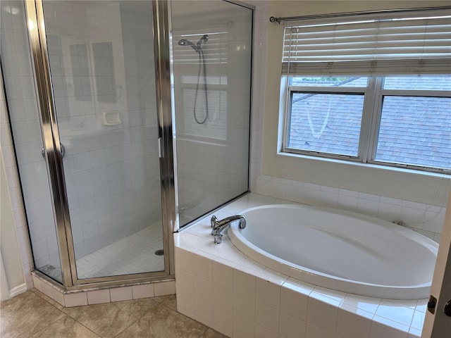 bathroom featuring independent shower and bath and tile patterned flooring