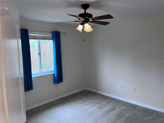 carpeted spare room featuring ceiling fan