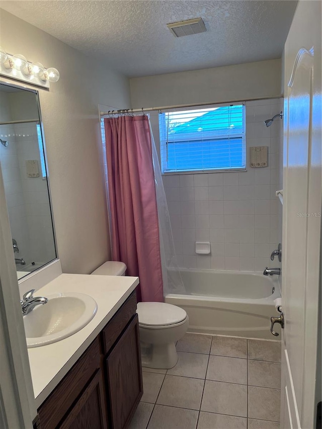 full bathroom featuring vanity, a textured ceiling, and toilet