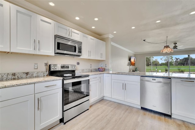 kitchen featuring sink, stainless steel appliances, light hardwood / wood-style flooring, white cabinets, and ornamental molding