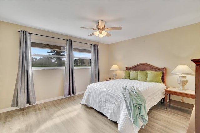 bedroom with light wood-type flooring and ceiling fan