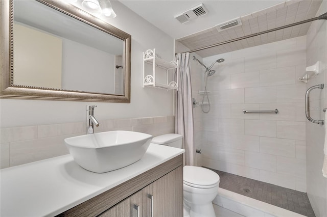 bathroom with curtained shower, vanity, and toilet