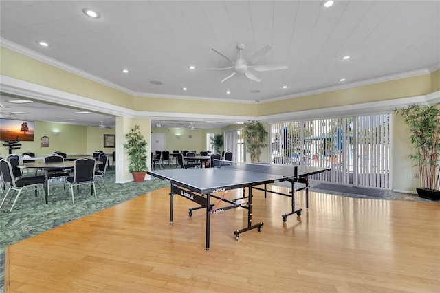 game room with light hardwood / wood-style flooring, ceiling fan, and crown molding