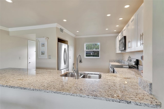 kitchen with visible vents, ornamental molding, light stone countertops, appliances with stainless steel finishes, and a sink