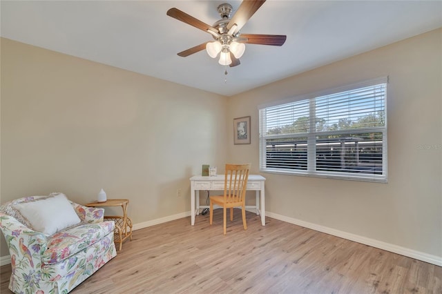 office featuring baseboards, wood finished floors, and ceiling fan