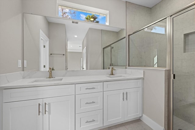 bathroom featuring vanity, tile patterned floors, walk in shower, and a healthy amount of sunlight