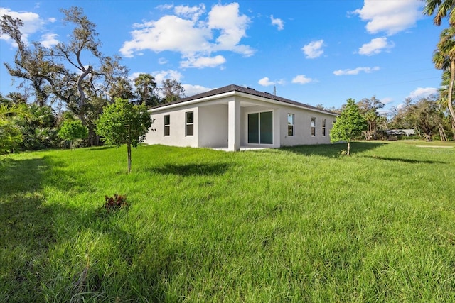 back of house with a yard