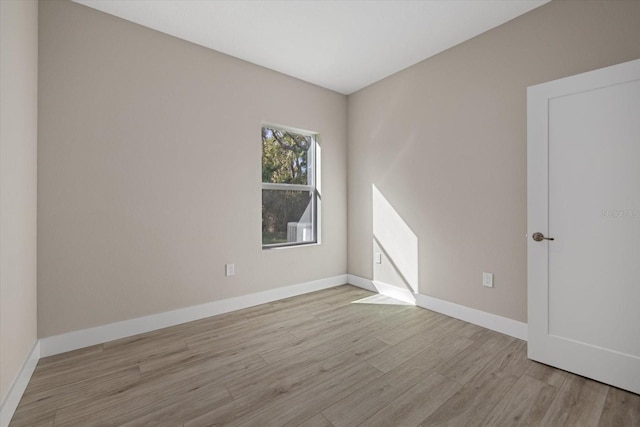 unfurnished room with light wood-type flooring