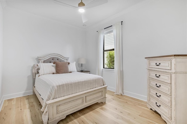 bedroom featuring ornamental molding, light hardwood / wood-style floors, and ceiling fan