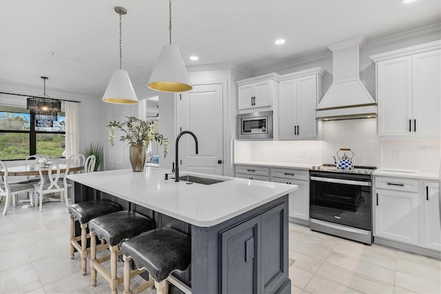 kitchen with stainless steel appliances, a center island with sink, sink, custom exhaust hood, and hanging light fixtures