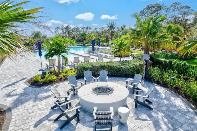 view of patio / terrace featuring a community pool and a fire pit