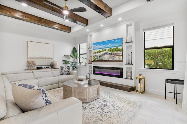 living room featuring beamed ceiling, a wealth of natural light, and ceiling fan