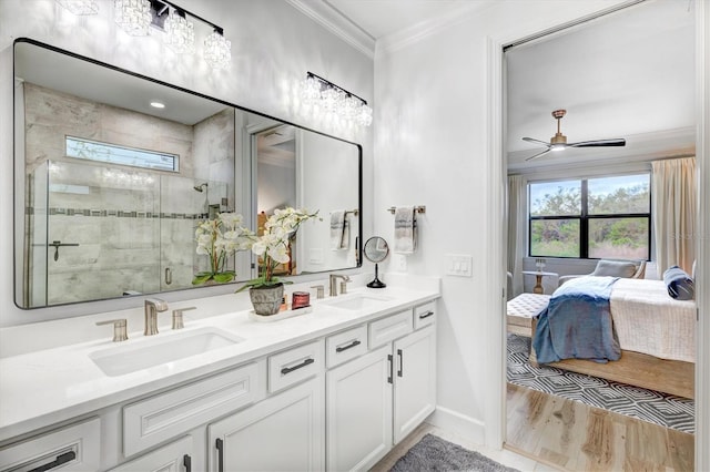 bathroom featuring wood-type flooring, vanity, ceiling fan, crown molding, and a shower with shower door