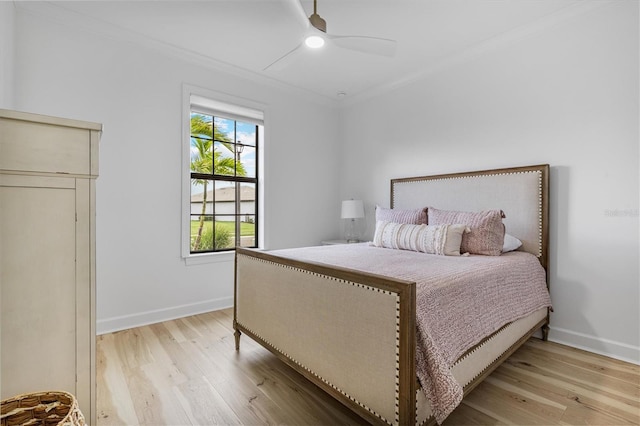 bedroom featuring ornamental molding, light hardwood / wood-style floors, and ceiling fan