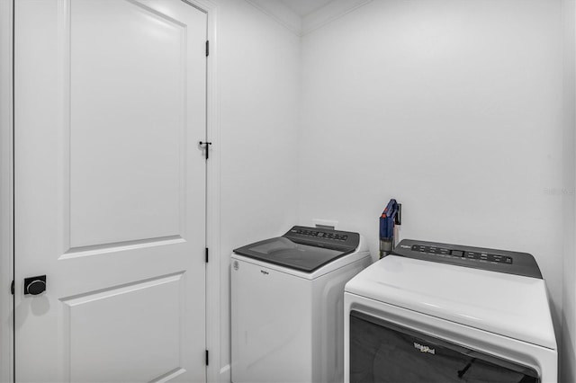 laundry area featuring independent washer and dryer and ornamental molding