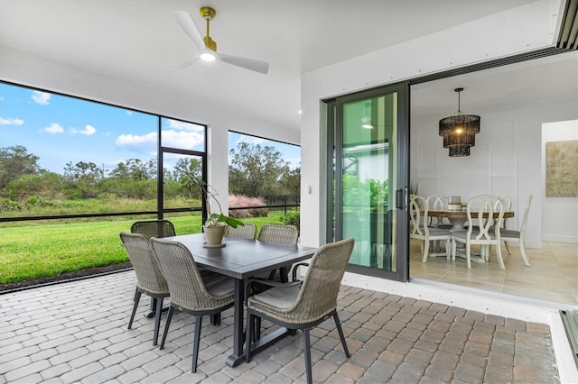 sunroom featuring ceiling fan