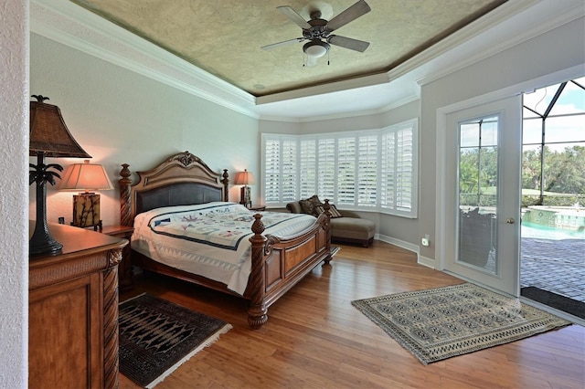 bedroom featuring access to outside, light hardwood / wood-style flooring, ceiling fan, and crown molding