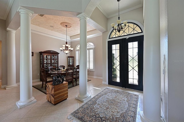 10209 Discovery Ter, Bradenton, FL 34212 - entryway with decorative columns, a chandelier, crown molding, light tile patterned floors, and baseboards