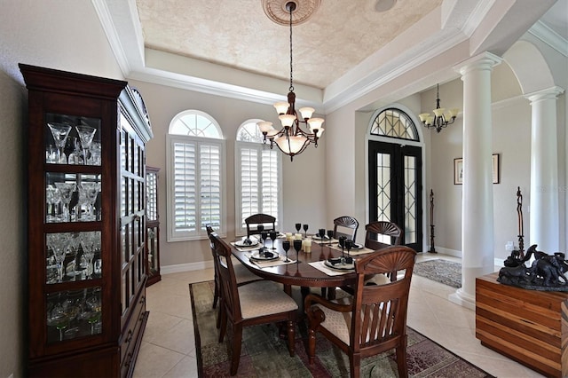 10209 Discovery Ter, Bradenton, FL 34212 - dining space featuring a tray ceiling, a chandelier, and light tile patterned floors